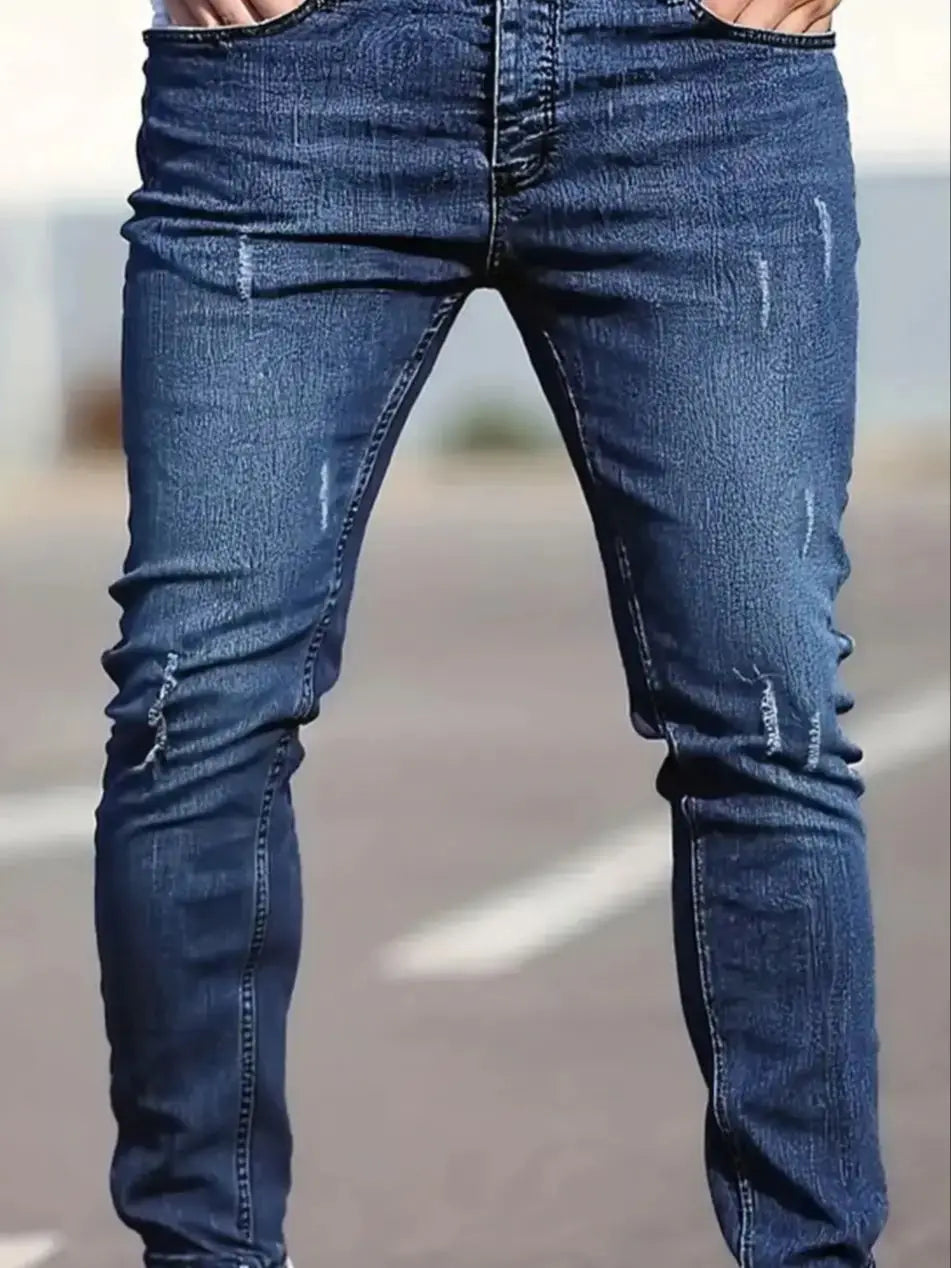 Men's slim-fit blue jeans with subtle distressing, contouring to the body, effortlessly creating a casual and trendy style.