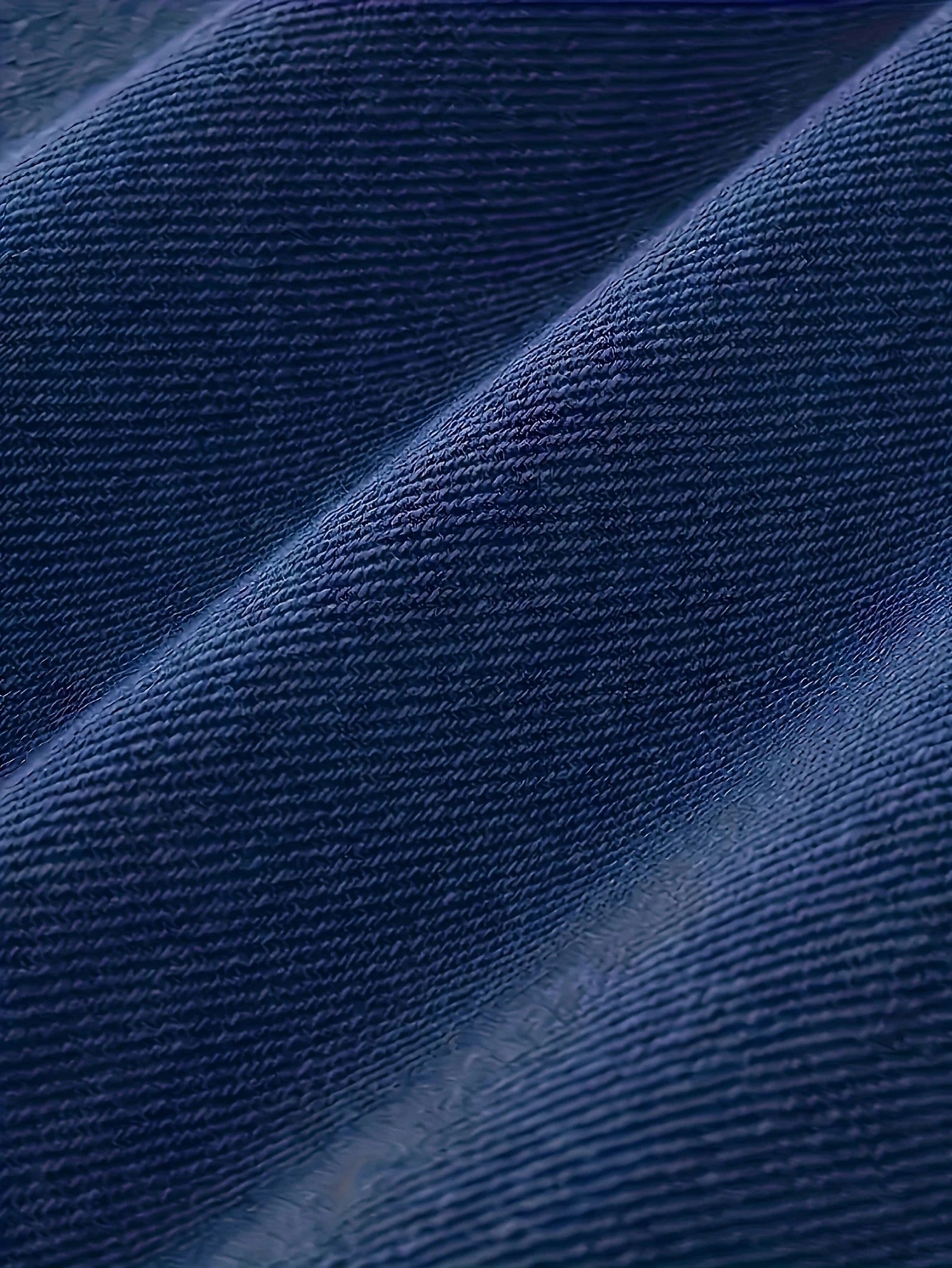 Men's slim-fit blue jeans with subtle distressing, contouring to the body, effortlessly creating a casual and trendy style.