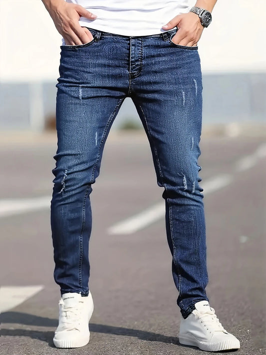 Men's slim-fit blue jeans with subtle distressing, contouring to the body, effortlessly creating a casual and trendy style.